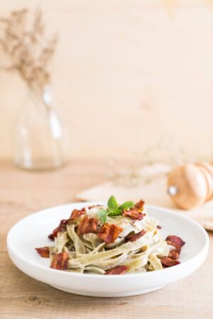 spinach fettuccine with cream cheese white sauce and bacon - Italian food styleの写真素材