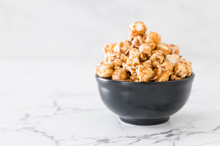 popcorn with caramel in bowlの写真素材