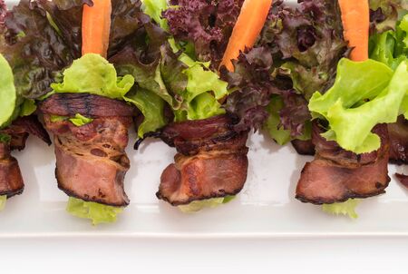 salad roll with bacon on white backgroundの写真素材