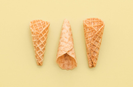 empty wafer cone on yellow backgroundの写真素材