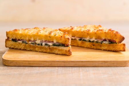 baked spinach and ham sandwich with sauceの写真素材