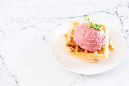 strawberry icecream with waffle on plateの写真素材