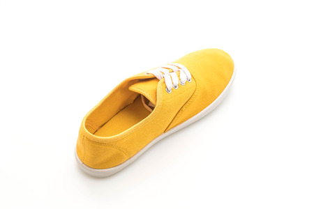 yellow sneakers isolated on white backgroundの写真素材