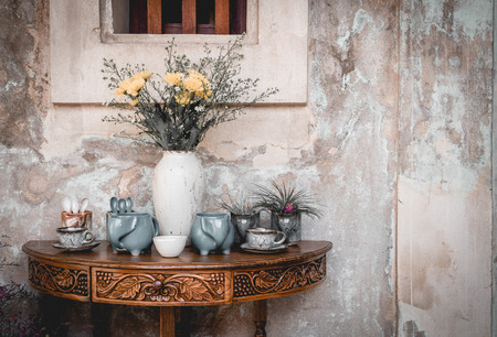 vase and decoration on vintage table with old wallの写真素材