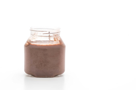 chocolate hazelnut spread jar isolated on white backgroundの写真素材