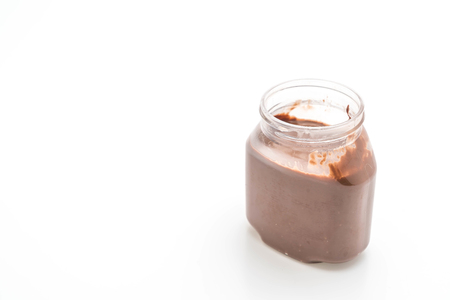 chocolate hazelnut spread jar isolated on white backgroundの写真素材