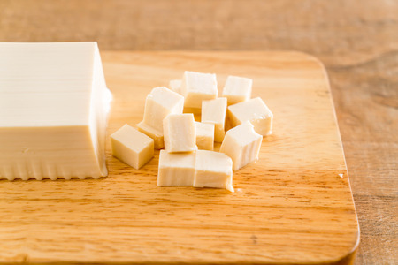 cube tofu on wooden board backgroundの写真素材