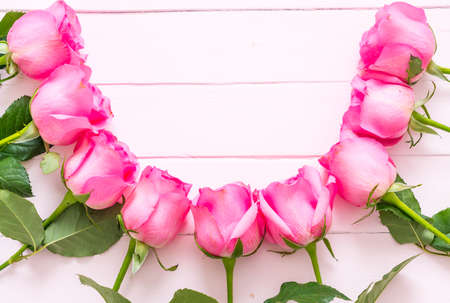 pink rose in vase on wood background with copy spaceの写真素材