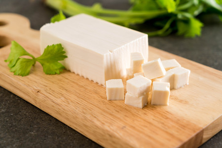 cube tofu on wooden board backgroundの写真素材
