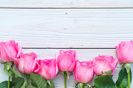 pink rose in vase on wood background with copy spaceの写真素材