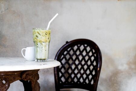 matcha green tea with milk in cafeの写真素材