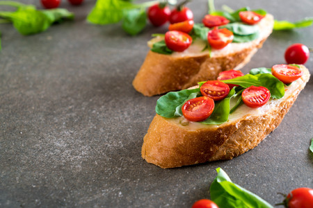 bread with rocket and tomatoes - healthy or vegan food styleの写真素材