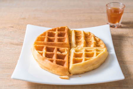 waffle with butter and honey on plateの写真素材