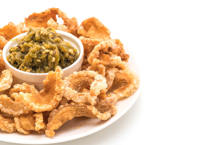 Fried pork rince or Pork snack with Nam Prik Num (Northern Thai Green Chilli Dip) isolated on white backgroundの写真素材