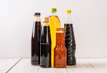 group of sauce bottle condiment for cooking on wood backgroundの写真素材