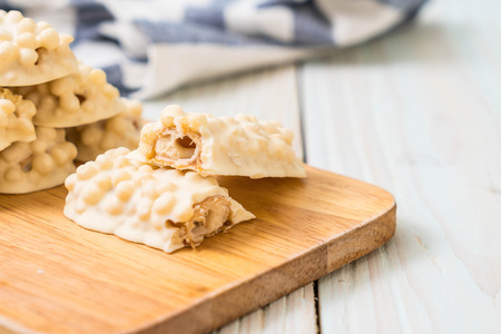 white chocolate with caramel and cereal crispy bar on woodの写真素材
