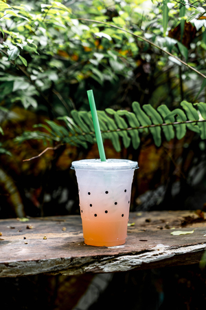 glass of lychee soda with tree backgroundの写真素材