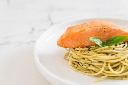 Pasta spaghetti with pesto green and salmon - Italian food styleの写真素材