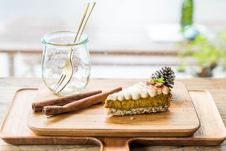 pumpkin pie cake on wood plate