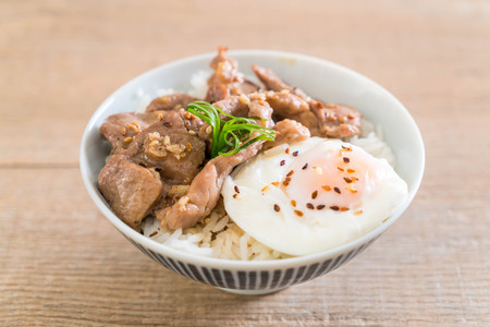 stir-fried pork with garlic on topped rice with egg - Asian food styleの写真素材