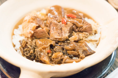 Baked rice with stewed pork leg in clay pot - Asian food styleの写真素材