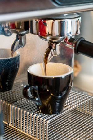 Close-up of coffee pouring from coffee machineの写真素材