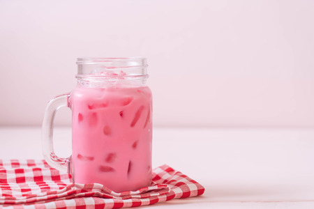 pink strawberry milkshake on woodの写真素材