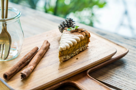 pumpkin pie cake on wood plate