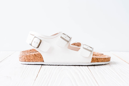 unisex leather sandals on wood backgroundの写真素材