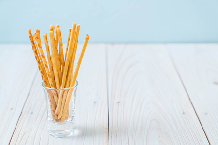 biscuit sticks on wood backgroundの写真素材