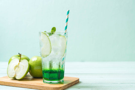 green apple soda on wood tableの写真素材