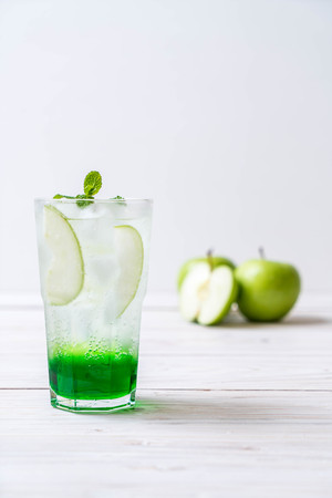 green apple soda on wood tableの写真素材