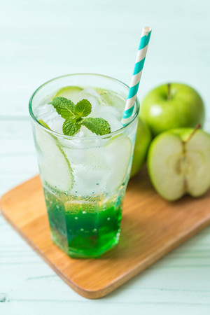 green apple soda on wood tableの写真素材