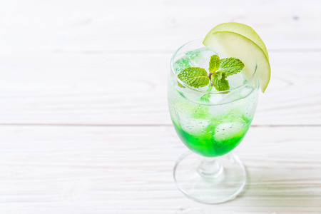 green apple soda on wood tableの写真素材