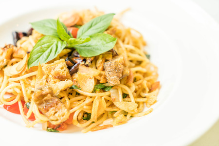 Stir-fried spaghetti and dried Gourami on plateの写真素材