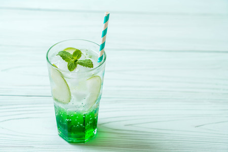 green apple soda on wood tableの写真素材