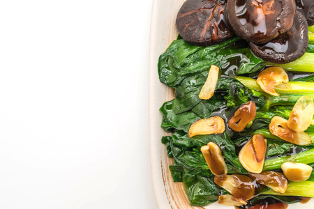 Hong Kong Kale stir fried in oyster sauce with garlic isolated on white backgroundの写真素材