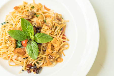 Stir-fried spaghetti and dried Gourami on plateの写真素材