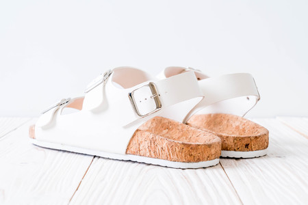 unisex leather sandals on wood backgroundの写真素材