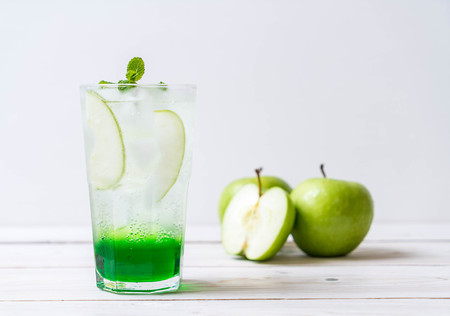 green apple soda on wood tableの写真素材