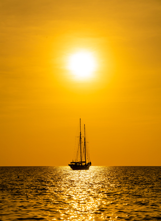 silhouette boat in sea and ocean with beautiful sunset sky - filter effect processing style