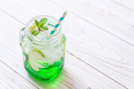 green apple soda on wood tableの写真素材