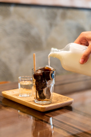 iced coffee cube in glass with milk - vintage effect filterの写真素材