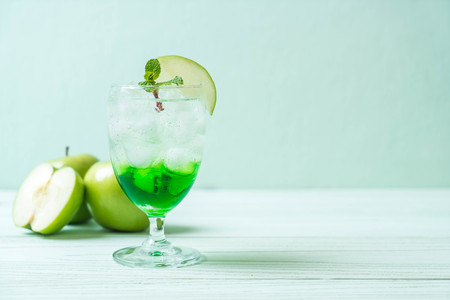 green apple soda on wood tableの写真素材