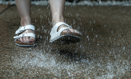 foot with leather shoe on rainy day - vintage effect filter