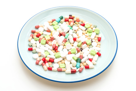 pills ,drugs ,pharmacy ,medicine or medical on plate isolated on white backgroundの写真素材
