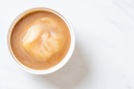 mash potatoes in gravy soup in cupの写真素材