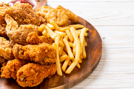 fried chicken with french fries and nuggets meal - junk food and unhealthy food