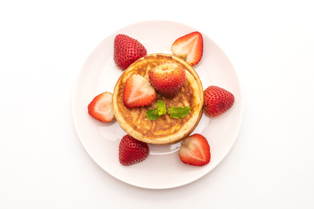 pancake with fresh strawberries isolated on white backgroundの写真素材