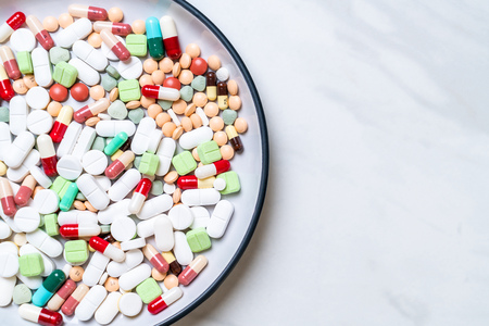 pills ,drugs ,pharmacy ,medicine or medical on plate - healthycare conceptの写真素材